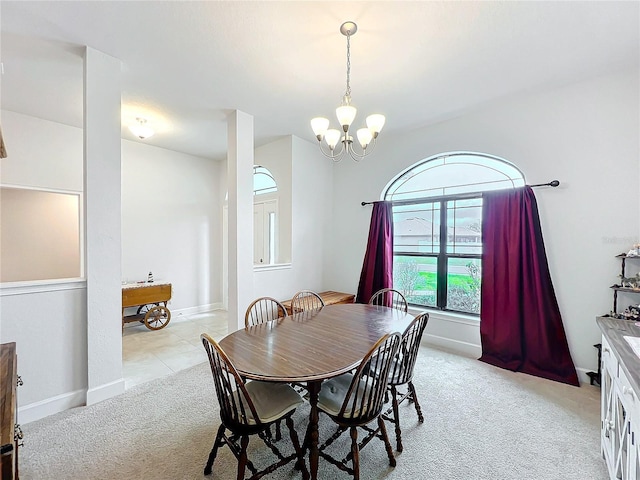 dining area featuring light carpet, baseboards, and an inviting chandelier