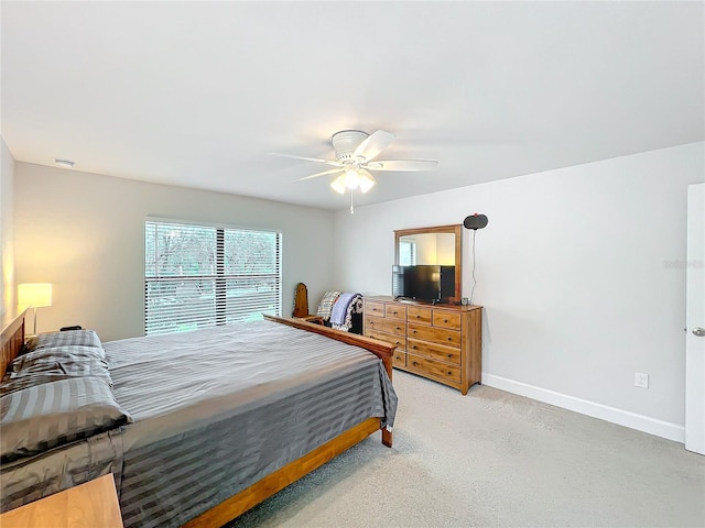 bedroom with ceiling fan, carpet flooring, and baseboards