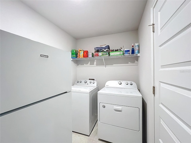 clothes washing area featuring laundry area and washer and clothes dryer