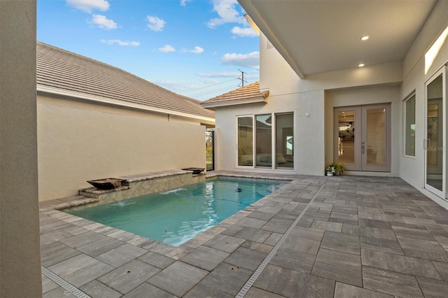 pool with a patio and french doors