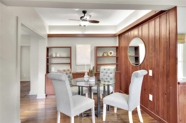 dining space featuring ceiling fan, baseboards, and wood finished floors