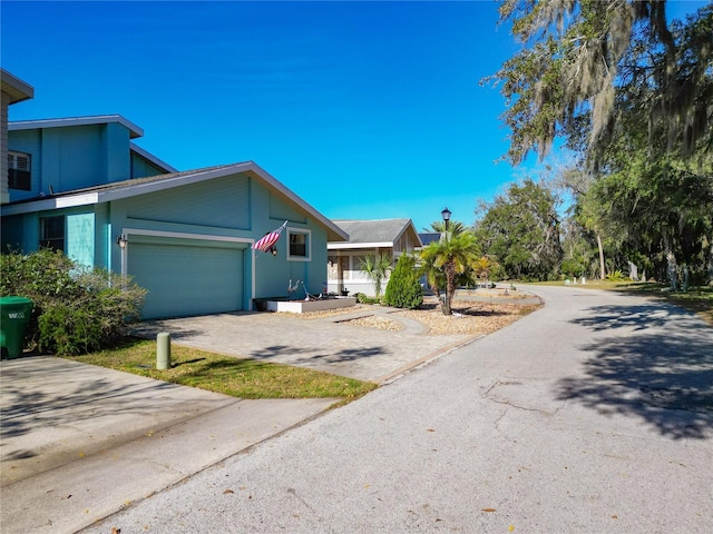 view of front of home with an attached garage and decorative driveway