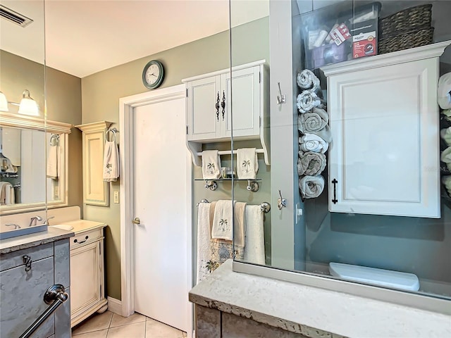 bathroom featuring visible vents, vanity, and tile patterned floors