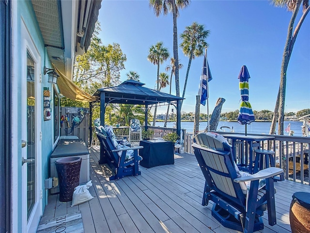 wooden deck featuring a gazebo and a water view