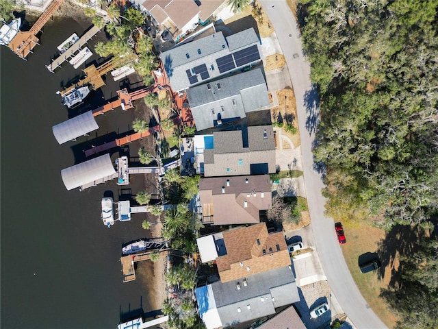 drone / aerial view with a water view and a residential view