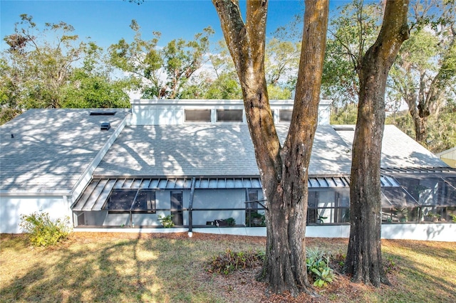 view of front of house with a lanai and a front yard