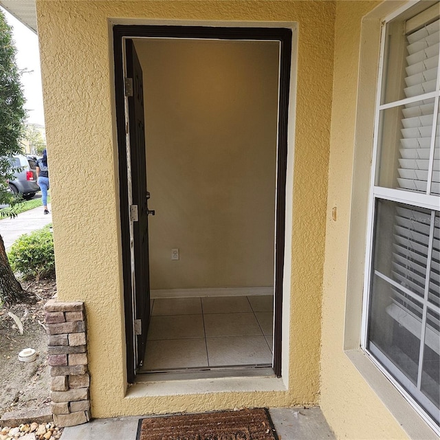 view of exterior entry with stucco siding