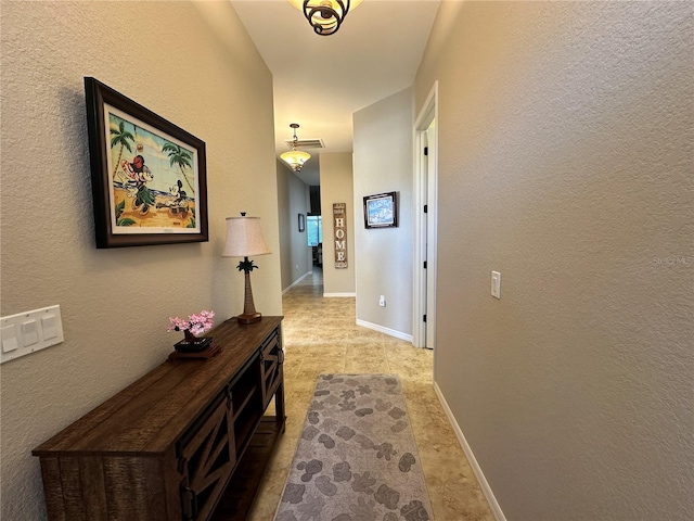 394 Nolane Ln, Polk City, FL 33868 - corridor featuring a textured wall, visible vents, and baseboards