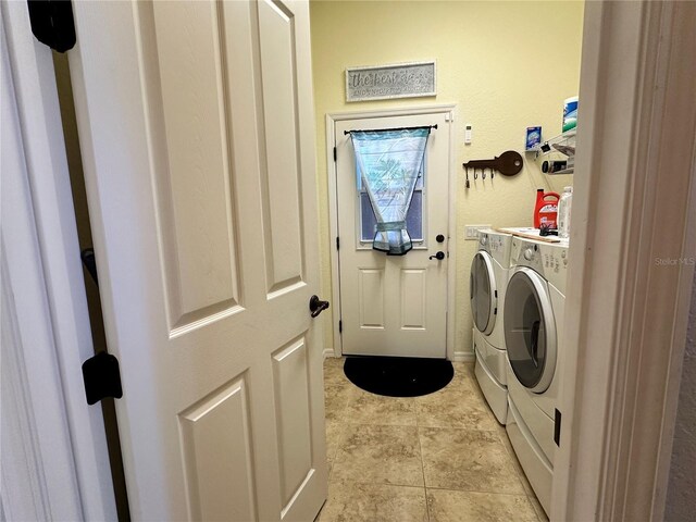 394 Nolane Ln, Polk City, FL 33868 - clothes washing area with washer and dryer, laundry area, and light tile patterned floors