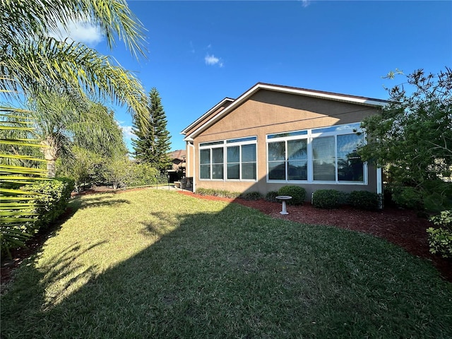 394 Nolane Ln, Polk City, FL 33868 - back of house with a yard and stucco siding