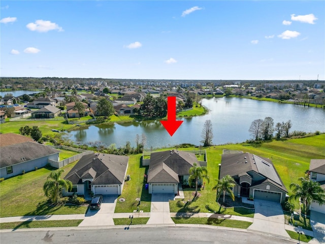 bird's eye view featuring a water view and a residential view