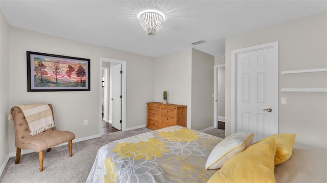 carpeted bedroom with baseboards, visible vents, and a textured ceiling