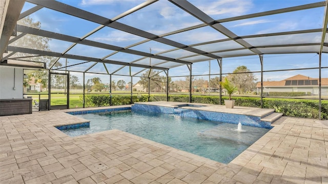 view of swimming pool featuring a lanai, a pool with connected hot tub, and a patio