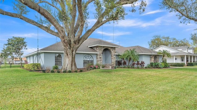 ranch-style house with a front lawn and stucco siding