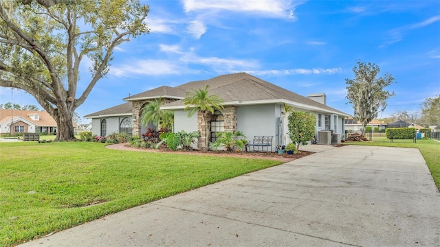 single story home with driveway, a front yard, fence, and stucco siding