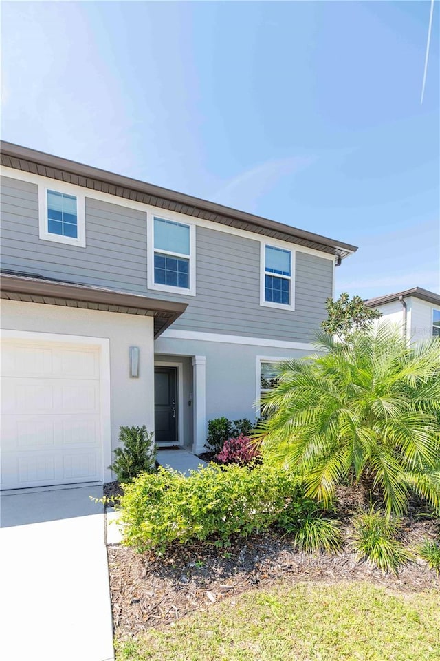 view of front of property featuring a garage and stucco siding