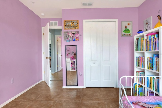 unfurnished bedroom with baseboards, visible vents, and a closet