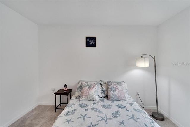 carpeted bedroom featuring baseboards