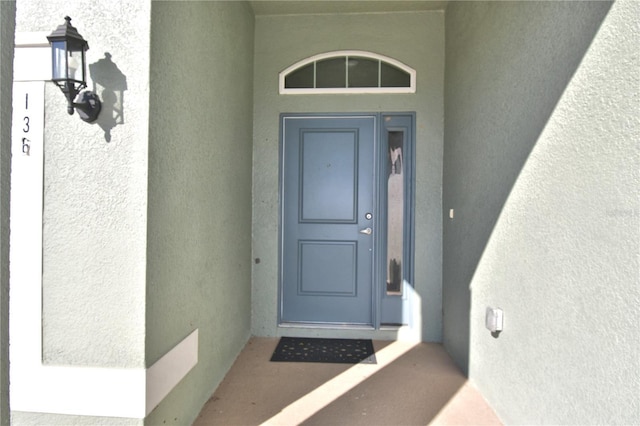 property entrance featuring stucco siding