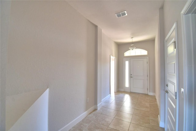 entrance foyer with baseboards, visible vents, and light tile patterned flooring