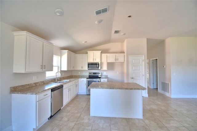 kitchen with white cabinets, a kitchen island, stainless steel appliances, and a sink