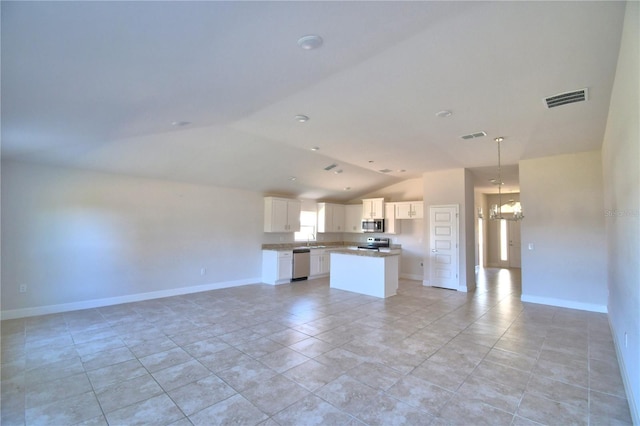 kitchen with visible vents, white cabinetry, open floor plan, appliances with stainless steel finishes, and a center island