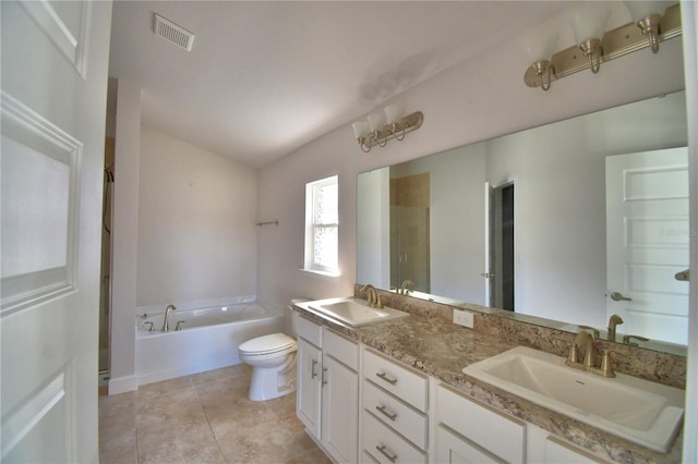 full bathroom featuring toilet, visible vents, a sink, and a garden tub