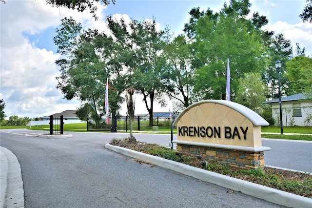 community sign featuring fence