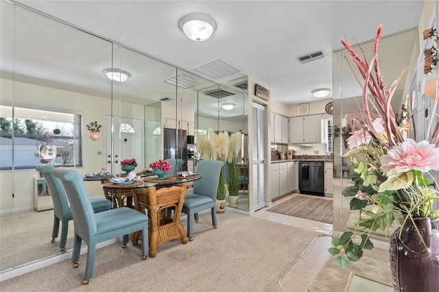 dining room with visible vents and light colored carpet