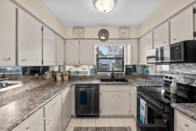 kitchen with light tile patterned floors, black appliances, backsplash, and a sink