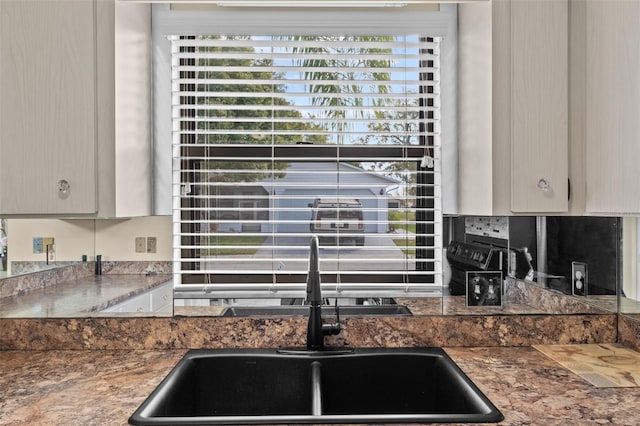 kitchen with dark countertops and a sink