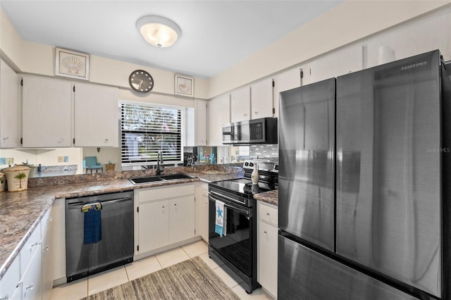 kitchen with stainless steel microwave, electric range, freestanding refrigerator, a sink, and dishwasher