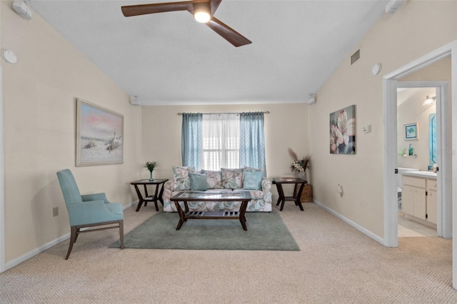 living room featuring light colored carpet, vaulted ceiling, baseboards, and ceiling fan