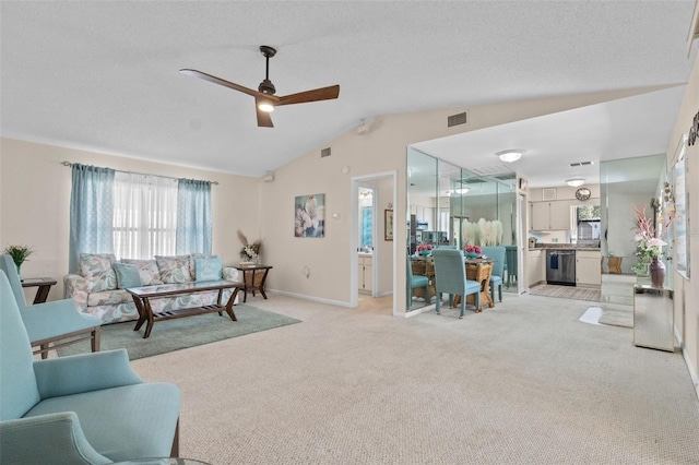 living room with light carpet, visible vents, ceiling fan, vaulted ceiling, and a textured ceiling