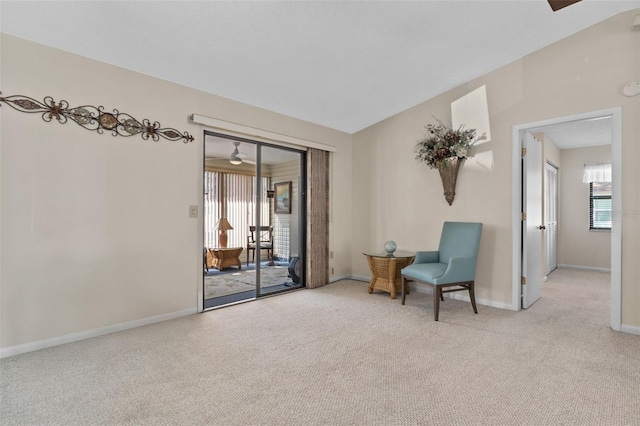 living area with light carpet, baseboards, and lofted ceiling