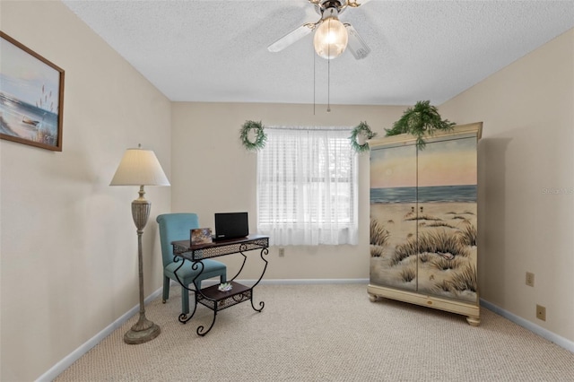 carpeted office space with baseboards, a ceiling fan, and a textured ceiling