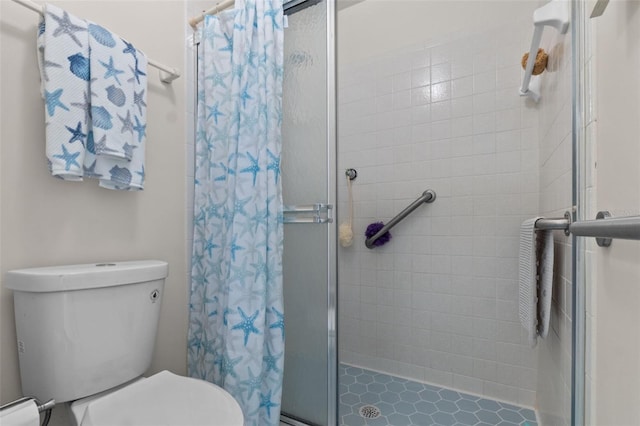 bathroom featuring toilet, a shower stall, and baseboard heating