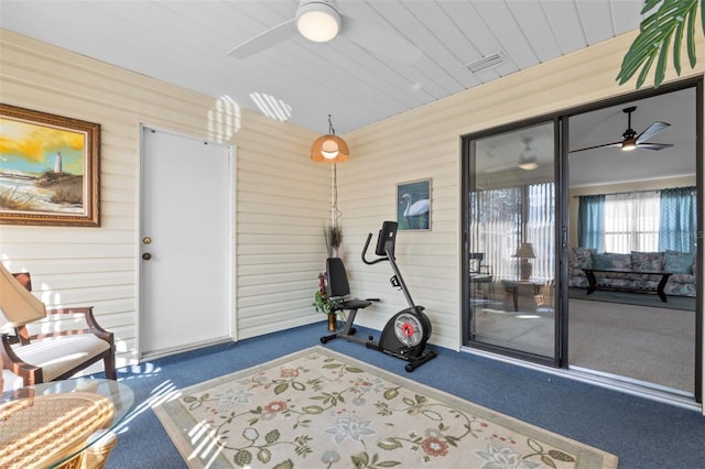 exterior space with a ceiling fan, wooden ceiling, and carpet flooring