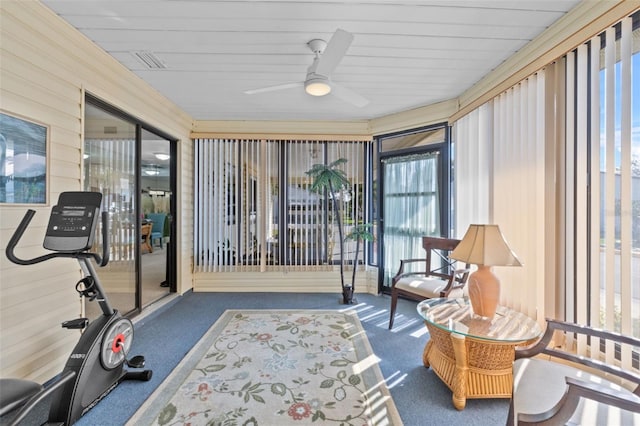 sunroom / solarium featuring a ceiling fan