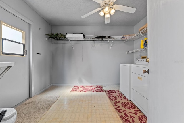 interior space featuring laundry area, ceiling fan, a textured ceiling, light floors, and washing machine and dryer