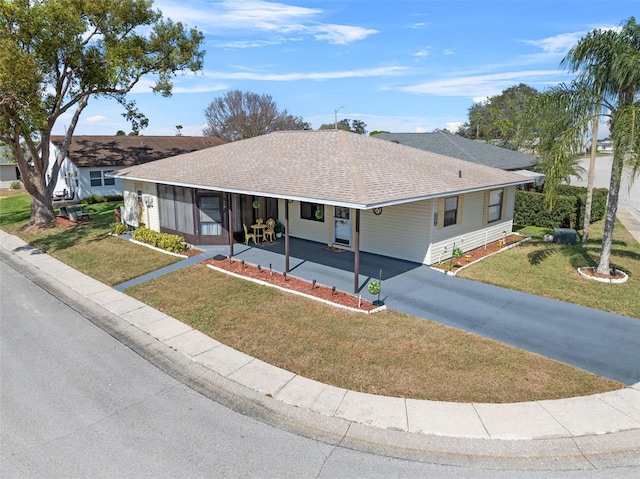 single story home with a front lawn, a shingled roof, and aphalt driveway