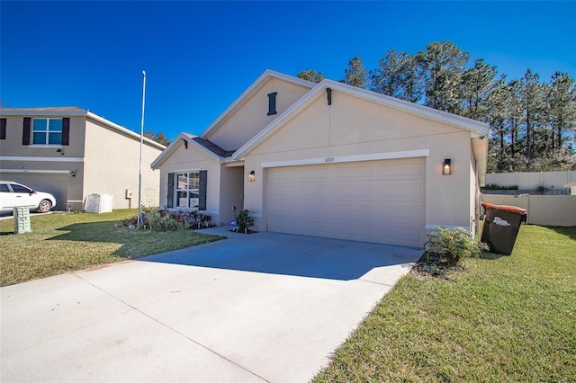 ranch-style house with concrete driveway, a front yard, fence, and stucco siding