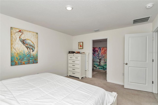6769 SE 3rd Loop, Ocala, FL 34472 - bedroom with light carpet, a walk in closet, a textured ceiling, and a closet