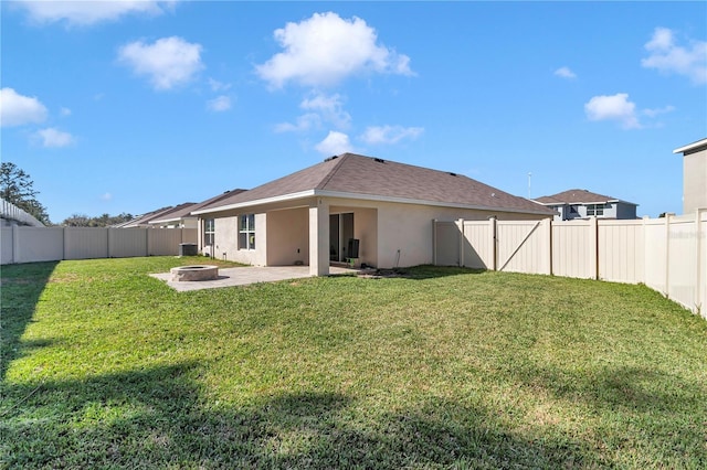 6769 SE 3rd Loop, Ocala, FL 34472 - rear view of property with a fire pit, a patio, a fenced backyard, and stucco siding