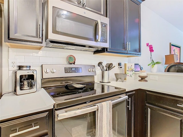 kitchen featuring light countertops, appliances with stainless steel finishes, and backsplash