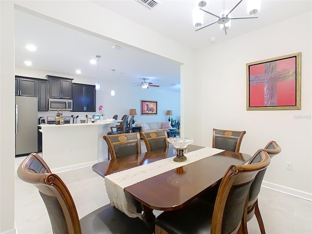 dining space featuring baseboards, ceiling fan with notable chandelier, visible vents, and recessed lighting