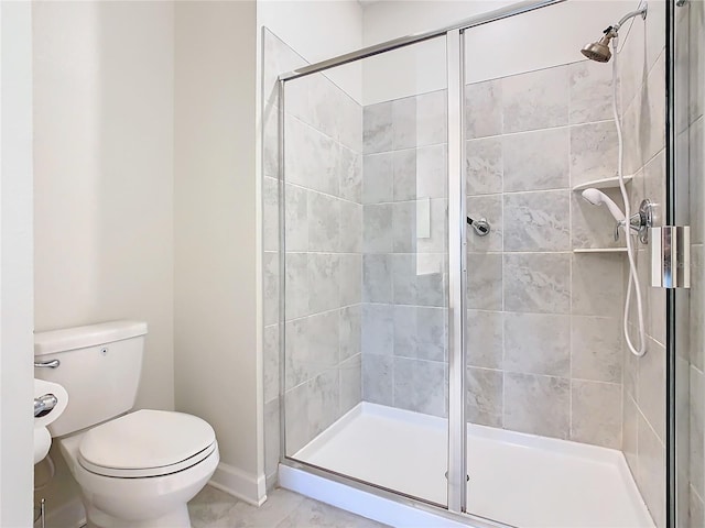 full bath with a stall shower, toilet, and baseboards