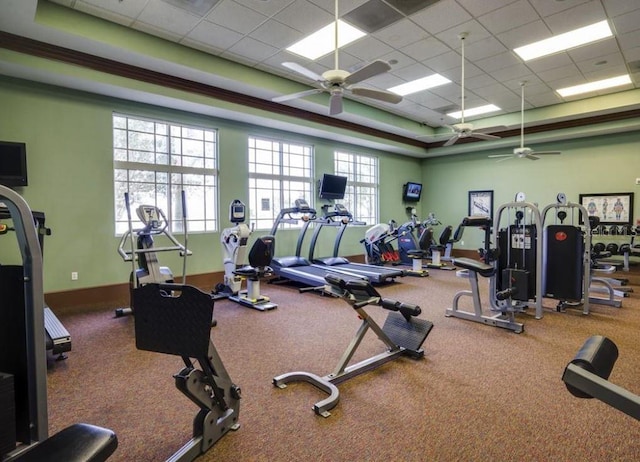 exercise room featuring ceiling fan, a drop ceiling, and baseboards