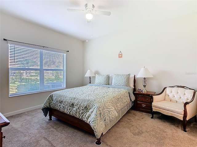 bedroom with baseboards, ceiling fan, and light colored carpet