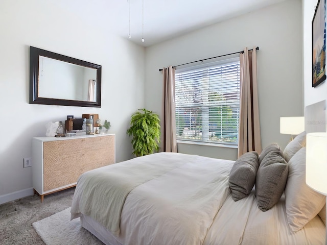 carpeted bedroom with baseboards